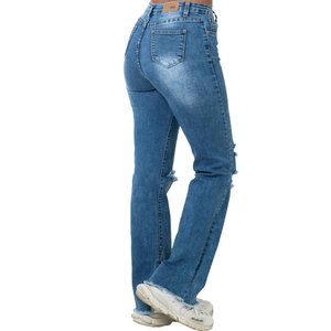Detail of blue flare jeans showing distressed knees and frayed hem for women