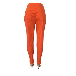 Detail view of the back of bright orange high-waisted slim fit jeans with pockets