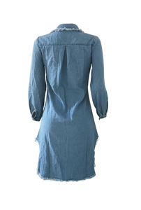 Detail view of the back of a blue denim dress with frayed edges and a center box pleat