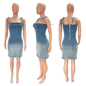 Detail view of gradient denim dress featuring adjustable bow straps and back metal zipper