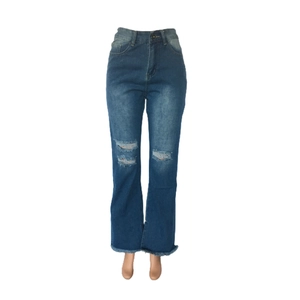 Detail view of dark blue flared jeans featuring distressed knees and raw fringe hems