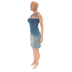 Detail of gradient wash denim dress showing backless halter neck and frayed hemline