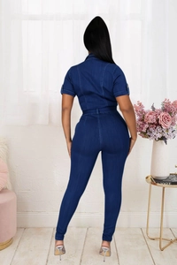 Rear view of slim fit dark blue denim jumpsuit with waist belt and short sleeves