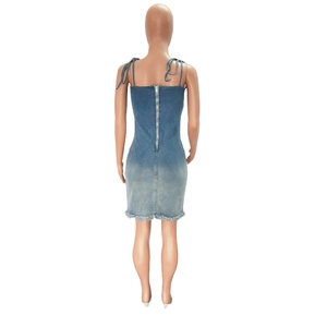 Close-up of the back zipper closure and frayed hem on this blue denim midi dress