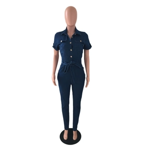 Detail of dark blue denim jumpsuit with turn-down collar and chest flap pockets