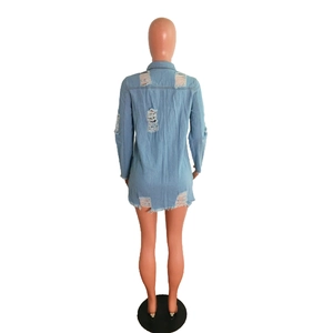 Detailed back view of light blue denim shirt dress featuring frayed hem and distressed rips