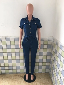 Detail of dark blue denim short sleeve jumpsuit with lapel collar and waist tie belt