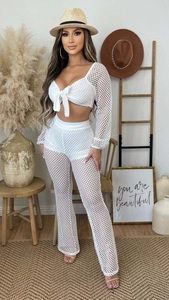 Detail view of white mesh two-piece cover-up set with tie-front crop top and high-waisted pants