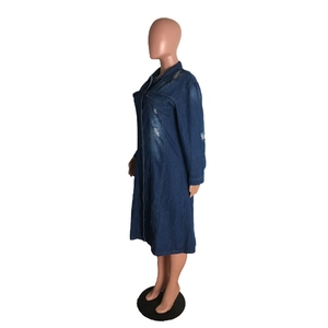 Detail of distressed dark blue denim shirt dress featuring raw hem and button-up closure