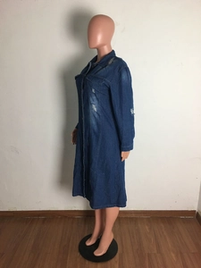 Detail of distressed dark blue denim shirt dress showing ripped texture and buttons