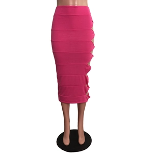 Detailed view of magenta midi skirt featuring side cut-outs and knotted bandage design