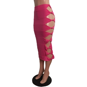 Detail of rose red high waisted midi skirt with side cut-outs and knot bow accents