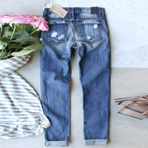 Women's blue washed denim jeans with distressed back pockets and cuffed hem detailing