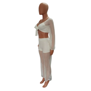 Close-up of white mesh two-piece set featuring lace-up top and wide-leg beach trousers