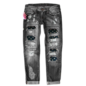 Mid-rise dark gray straight leg jeans with distressed ripped details and star patches