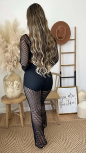 Back view of black mesh two-piece set featuring long-sleeve crop top and wide-leg trousers