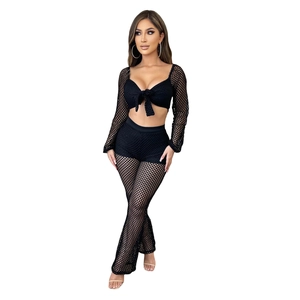 Close-up of black mesh two-piece set featuring long-sleeve crop top and flare trousers
