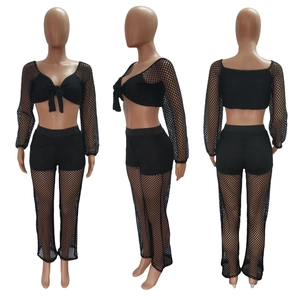 Close-up of black mesh beach set featuring front tie long sleeve crop top and high waist pants