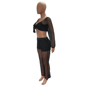 Detail of black mesh two-piece beach set featuring tie-front cardigan and sheer pants