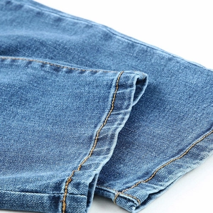 Fashionable mid-waist blue baseball jeans with yellow double-needle stitching on the hem