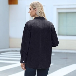 Rear view of dark grey denim shirt showing V-shaped back yoke and curved hemline