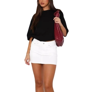Detail shot of white denim mini skirt with metal buttons and classic pockets