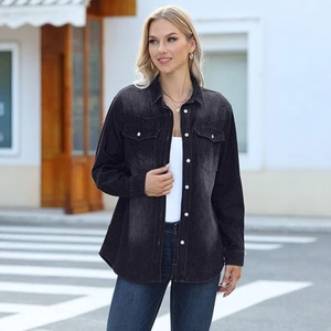 Detail of dark grey washed denim shirt featuring white buttons and front flap pockets