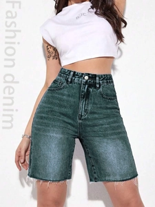 Detail view of high waisted denim shorts with metallic button and raw fringe hem
