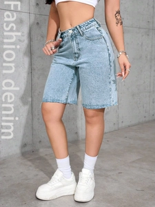 Close-up of light blue high-waisted denim shorts featuring trendy frayed raw edges
