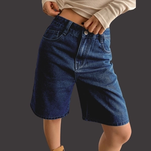 Women high waisted stretchy denim shorts in dark blue wash shown on model