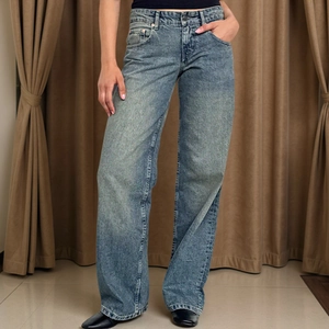 Women's vintage light wash wide leg denim jeans with high waist and distressed texture