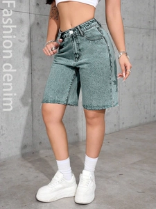 Detail shot of high-waisted denim shorts featuring vintage wash and frayed raw hem edges