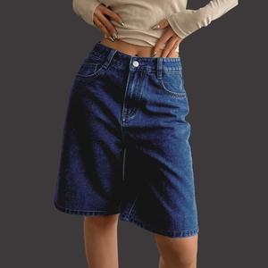 Detailed view of high-waist dark blue denim Bermuda shorts with classic silver button