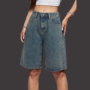 Detailed view of high waisted denim bermuda shorts featuring classic five-pocket styling