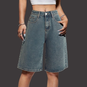 Detail of high waisted retro washed blue denim bermuda shorts with pockets