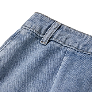 Close-up of light blue denim skirt waist with yellow double stitching and belt loops