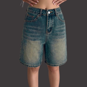 Women's high waist loose Bermuda denim shorts in vintage washed blue with whiskered details