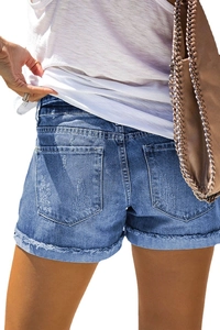 Distressed blue denim shorts with rolled hems and raw edges seen from a back view
