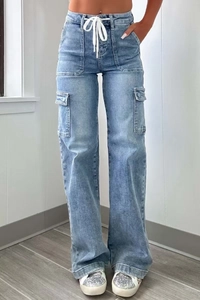 Detail view of light blue cargo jeans with functional white drawstring and large side pockets