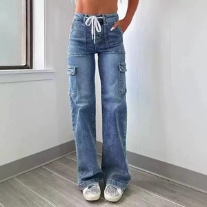 Close-up of high-waisted blue cargo jeans featuring large flap pockets and white drawstring
