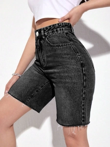 Detail of high waisted grey denim shorts with distressed wash and raw hem design