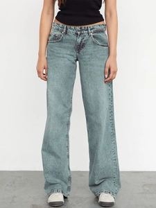 Macro detail of high-waist wide-leg jeans in snow wash light blue vintage denim