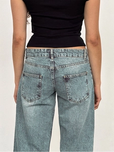 Rear view detail of vintage light blue wide-leg jeans with symmetrical back pockets