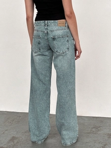 Detail view of high waist wide leg jeans with vintage snow wash and leather back patch