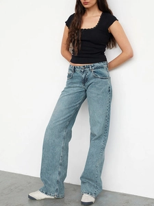 Detail of light blue high-waisted wide-leg denim jeans with a premium washed finish
