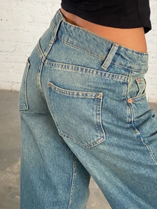 Detailed close-up showing the fit and high-quality denim texture of blue wide-leg jeans