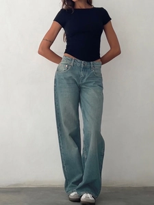 Detail shot of high-waisted wide-leg denim jeans in light blue with slim black t-shirt