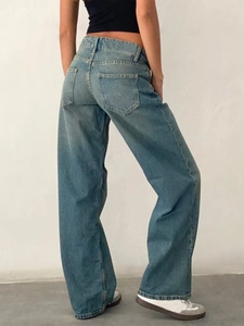 Detail view of the back pockets and loose fit cut of light blue wide leg denim jeans