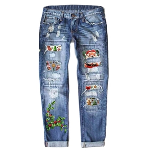 Women's light blue distressed straight jeans with festive Christmas themed holiday patches