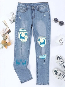 Women's blue wash ripped jeans with festive Christmas elk and snowflake printed patches